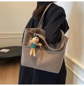 Corduroy tote bag for women, large capacity casual shoulder bag with cute rabbit plush pendant.