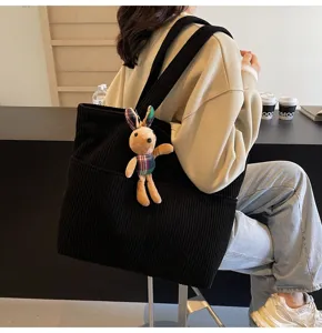 Black corduroy tote bag for women, casual large capacity shoulder handbag with cute rabbit pendant.