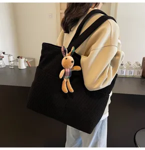 Black corduroy tote bag with cute plush rabbit pendant, large capacity casual shoulder bag.