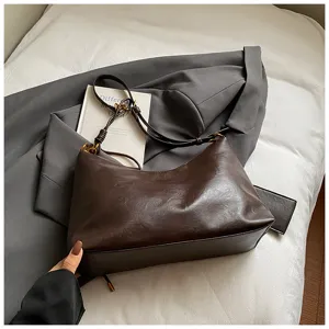 Brown leather vintage shoulder bag detail view, casual hobo bag for women autumn fashion.