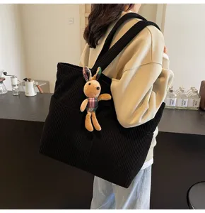 Stylish corduroy tote bag for women, casual large capacity shoulder bag with cute rabbit pendant.