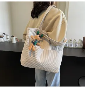 Chic corduroy tote bag for women with cute plush bunny pendant, large capacity shoulder bag.