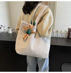 Beige corduroy tote bag for women with plush rabbit doll, large capacity casual handbag.