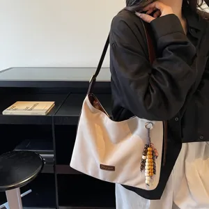 Retro suede shoulder bag for women, stylish underarm hobo bag for autumn commuting.