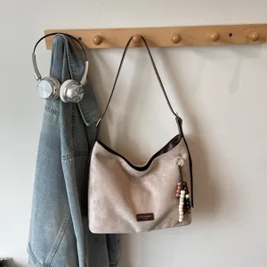 Vintage suede shoulder bag for women, stylish underarm hobo bag for daily casual commute.