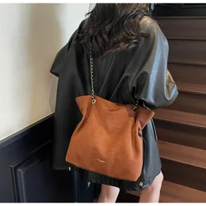 Detailed view of the brown suede chain tote bag with drawstring, stylish autumn accessory.