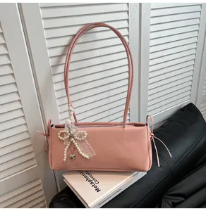 Chic pink shoulder bag for women, featuring elegant pearl lace bow and dual straps.