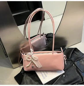 Pink shoulder bag with elegant lace pearl bow detail, stylish commuter PU leather handbag.