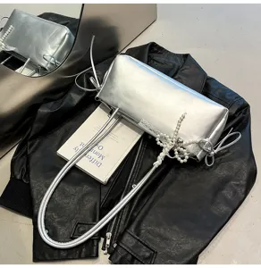 Silver metallic shoulder bag with elegant pearl lace bow decoration, trendy underarm handbag.