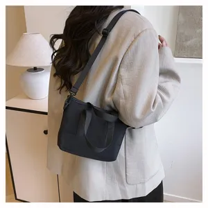 Minimalist black canvas crossbody shoulder bag for women, stylish daily casual small handbag.