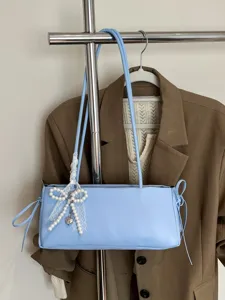 Light blue shoulder bag for women, elegant commuter underarm bag with pearl bow charm.