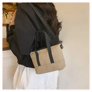 Detailed view of casual canvas crossbody bag, solid beige with black straps for daily wear.