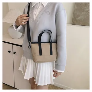 Casual minimalist canvas shoulder bag detail, contrast color design with top handle.