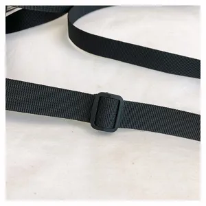 Close-up detail of the black adjustable bag strap and durable plastic buckle for daily use.