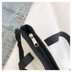 Detail view of Japanese casual solid color canvas shoulder messenger bag zipper handle.