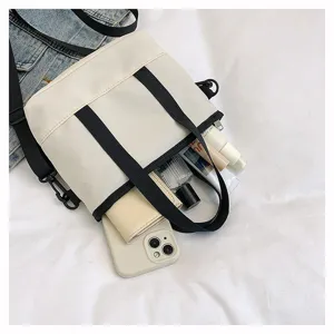 Casual white canvas crossbody bag for women, minimalist daily shoulder bag detail view.
