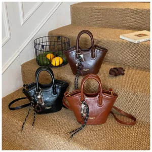Detailansicht von Vintage PU Leder Damenhandtaschen in drei klassischen Farben auf Treppen.