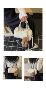 Retro oil wax leather pillow bag, stylish handbag with plush puppy charm for daily wear.