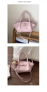 Chic pink leather handbag detail, stylish shoulder strap and elegant metal buckle design.
