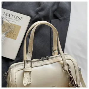 Vintage oil wax leather pillow bag for women, elegant small handbag with top handles and zipper.