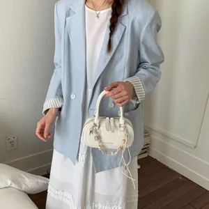 Chic white mini bowling bag for women, trendy crossbody shoulder handbag for daily wear.
