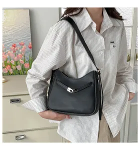 Black shoulder bag detail shot, minimalist hobo design with metal lock and daily commute style.
