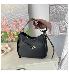 Detailed view of black women shoulder bucket bag featuring metallic clasp and zipper design.