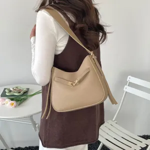Chic khaki shoulder bag with metal lock closure, perfect for daily commuting and elegant spring wear.