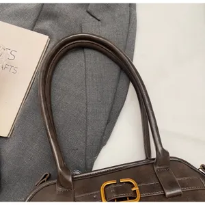 Retro brown shoulder bag detail shot, premium PU leather with vintage metal buckle design.