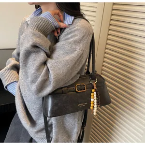 Classic black leather underarm shoulder bag for women, retro style commute handbag with charm.