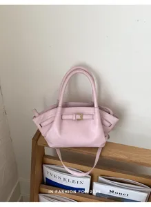 Pink leather handbag for women, stylish slouchy tote bag with buckle and shoulder strap.