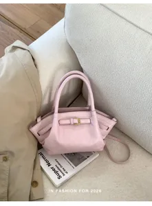Pink leather handbag for women, stylish tote and crossbody bag with chic buckle detail for daily wear.