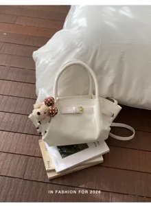 Elegant white top handle handbag featuring a chic belt buckle design and cute bear charm.