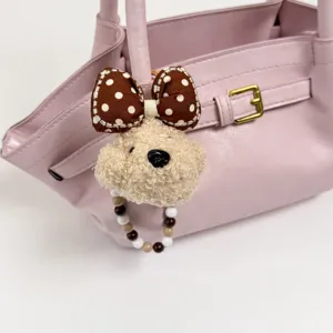 Stylish pink tote handbag featuring cute plush bear keychain and bow for women chic daily