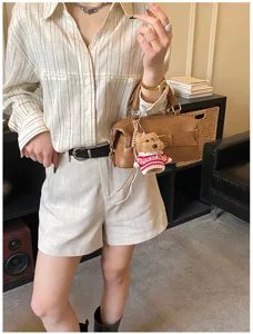 Chic brown Boston shoulder bag for women, trendy bowling handbag with cute plush bear charm.
