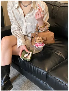 Chic brown bowling handbag boston shoulder bag with cute bear pendant for women spring style.