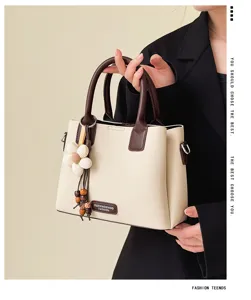 Retro stylish shoulder bucket bag with flower charm, premium PU leather handbag in two-tone design.