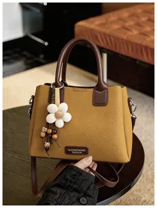 Retro fashion top handle shoulder bag for women, chic crossbody bucket bag with flower charm.