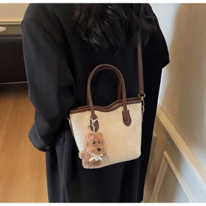Retro contrast-color bucket bag detail view with premium PU leather and cute bear charm.