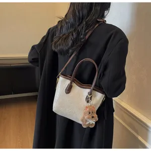 Retro bucket bag for women, stylish contrast color shoulder crossbody bag with cute bear charm.
