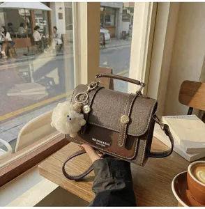 Vintage women's crossbody bag PU leather retro satchel purse with cute plush charm.