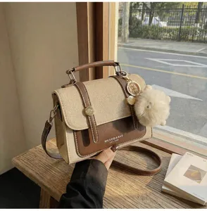Retro canvas and leather shoulder bag for women, classic crossbody square bag detail.