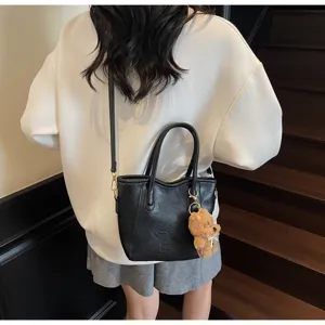 Black retro bucket bag with shoulder strap and cute bear charm for women daily fashion style