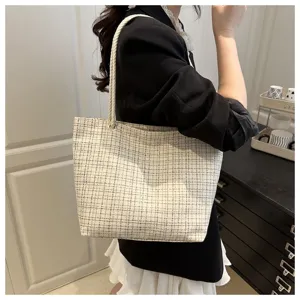 Detail view of casual plaid canvas tote bag with thick rope straps, spacious daily carry.