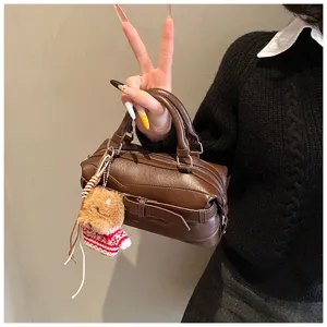 Brown leather bowling bag with cute bear charm, vintage style handbag for women spring fashion.
