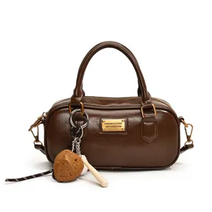 Brown PU leather Boston handbag for women casual shoulder bag with baseball charm.
