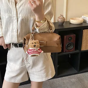 Stylish brown Boston handbag for women, chic shoulder crossbody bag with cute teddy bear charm.