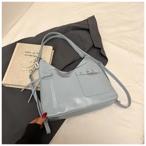 Detail view of light blue soft leather multi-way shoulder bag showing front zipper pocket.