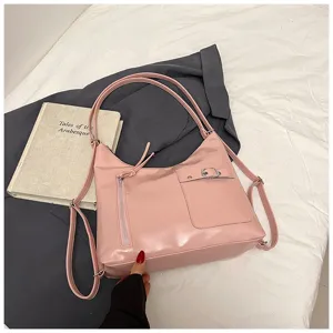 Pink soft leather multi-way shoulder bag detail view showing front zipper pocket and stylish buckle.
