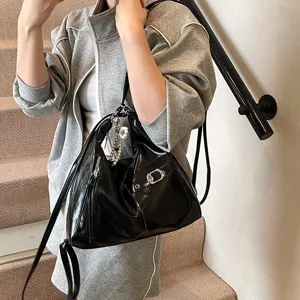 Stylish black patent leather slouchy shoulder bag, large capacity multi-way tote for women.